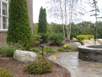 Patio and plantings showing fire pit and surround