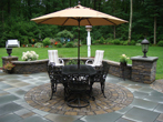 Patio renovation showing table and umbrella over circular pattern